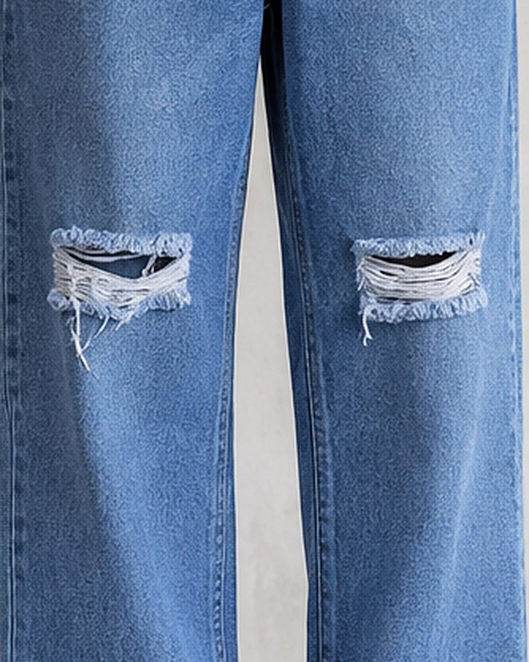 Close-up of knee rips on light blue baggy jeans for men – Arshmee Fashion