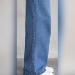 Side view of light blue wide leg jeans over white sneakers – Arshmee Fashion